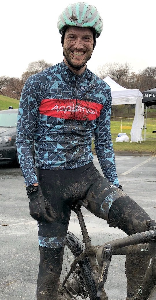 Matt Appleman at a cyclocross race, covered in mud with Appleman kit